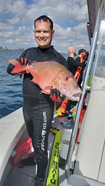 Reeling in a trophy Snapper on a West Palm Beach fishing charter.