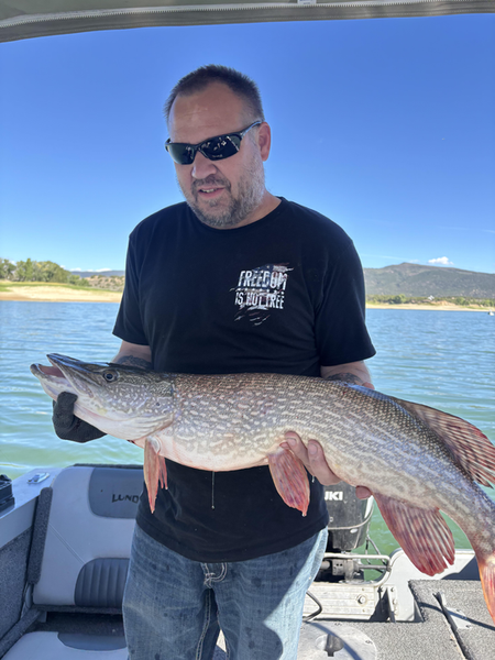 Nice Northern Pike using deep sea jigging technique in partly cloudy conditions.