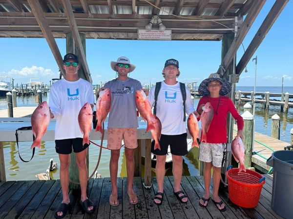 Proud anglers with red snapper catches.