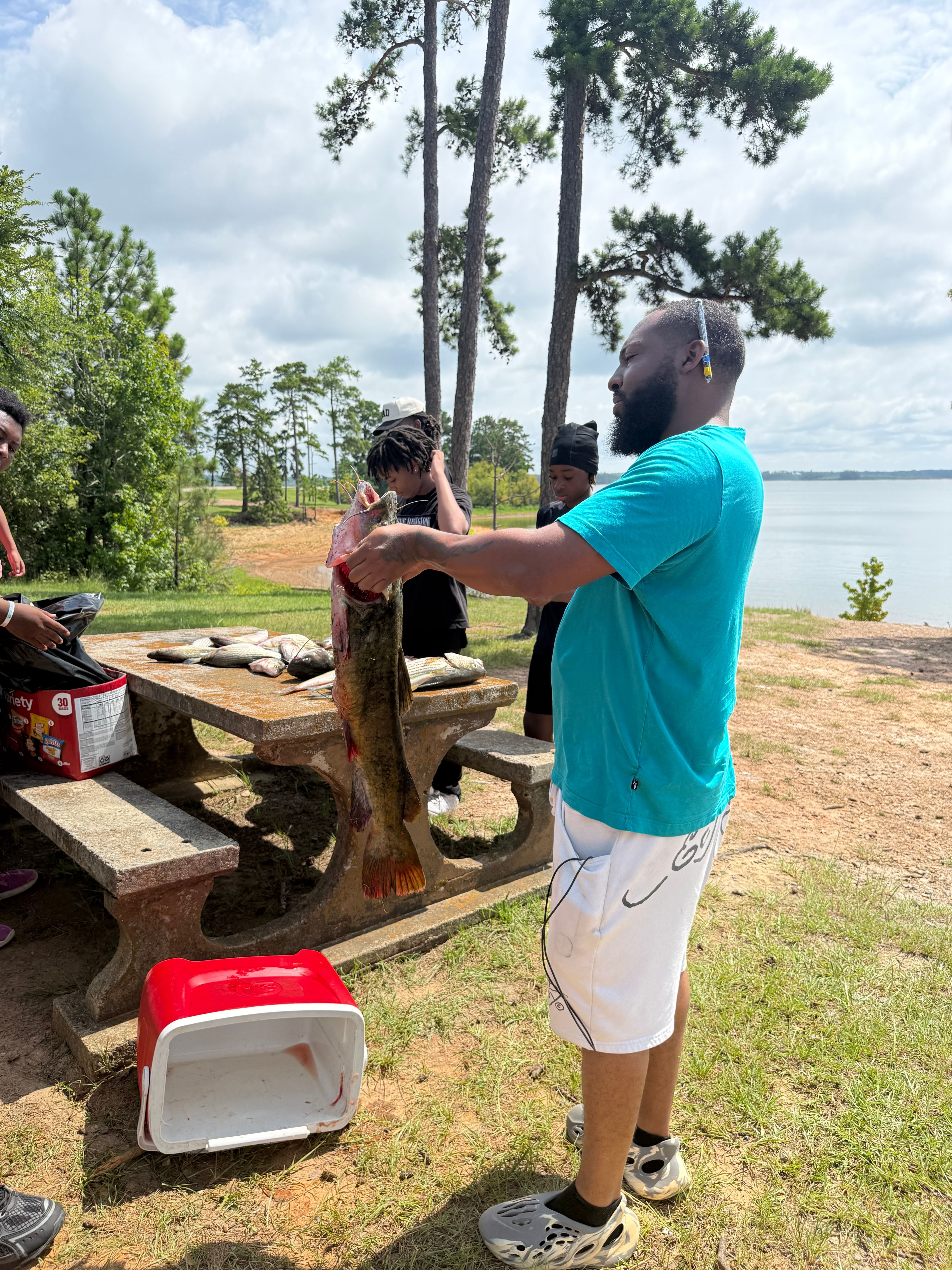 Freshly caught flathead catfish displayed on wooden surface outdoors