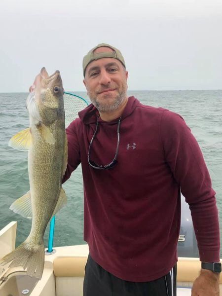 Angler with big fish on the line at unknown location