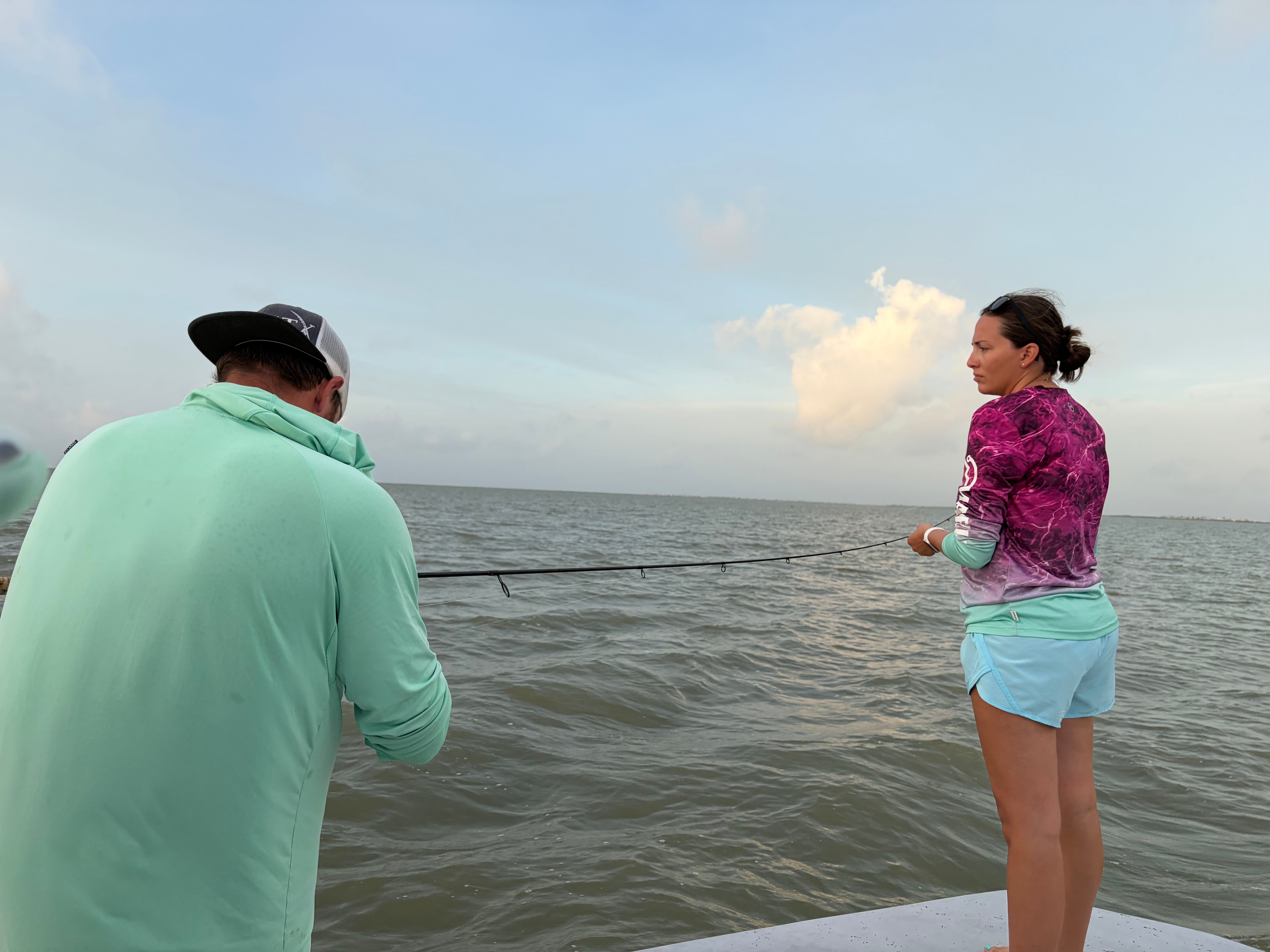 Fishing from boat with rod extended over water