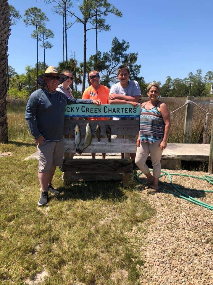 Five people enjoying a day of fishing