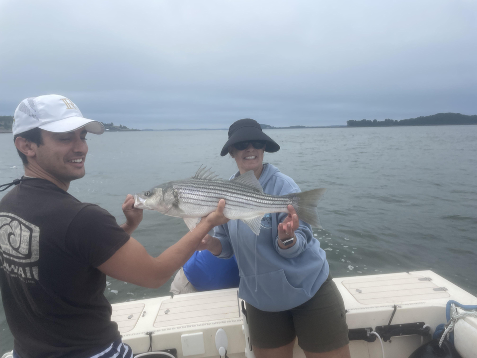 Reeling in a 20-inch Striped Bass on a partly cloudy day!