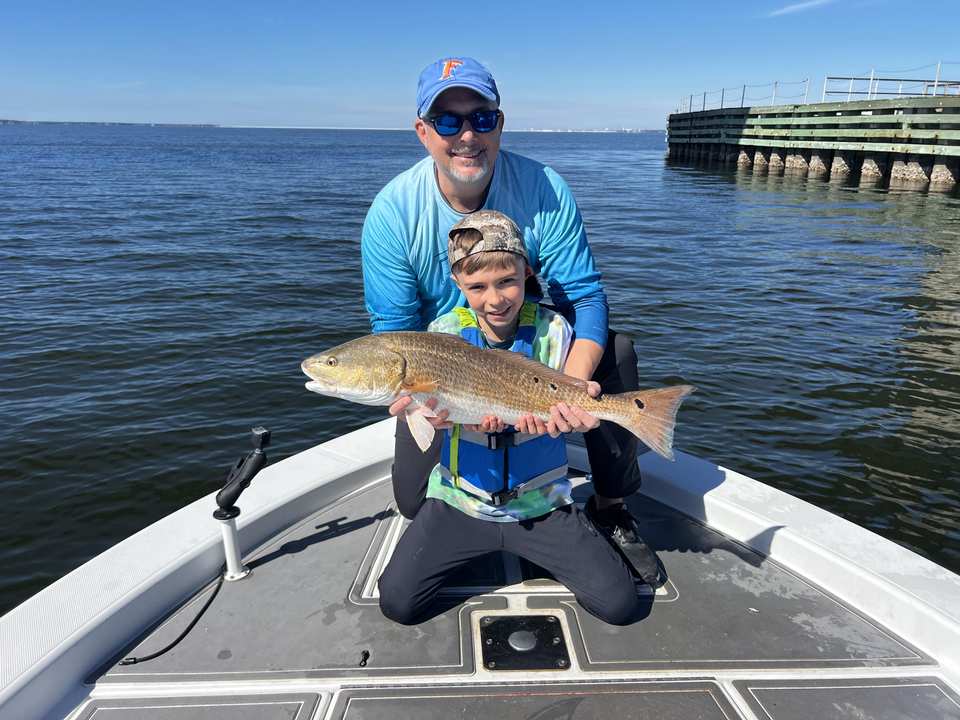 A calm day on the water, reeling in a catch.