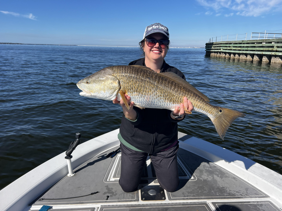 Reeling in the big one out on the water.