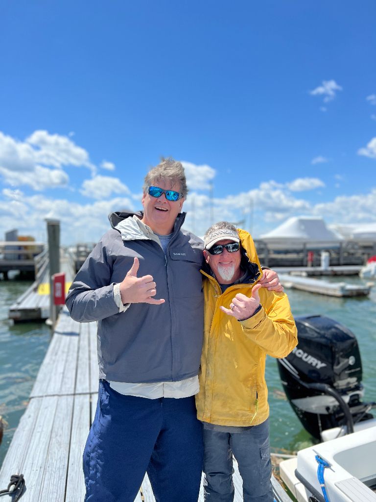 Two people fishing in an unknown location