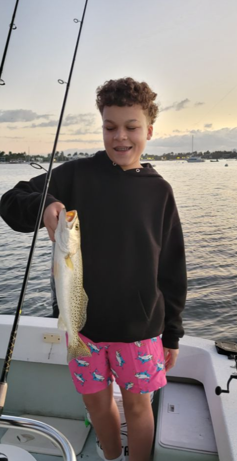 A person fishing in an unknown location