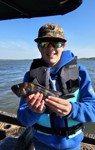 A single angler fishing in an unknown location