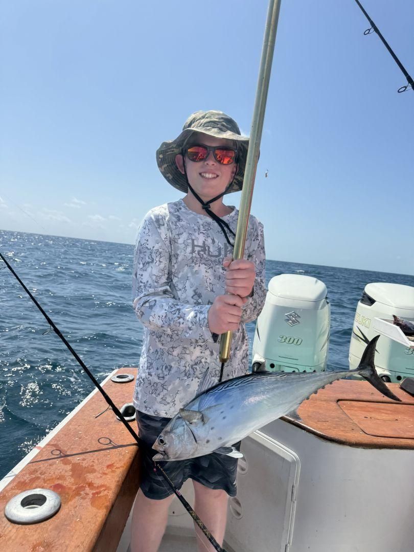 A lone fisherman with a fishing rod in an unknown location