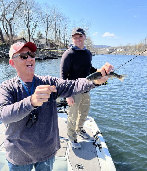 Two people fishing at an unknown location
