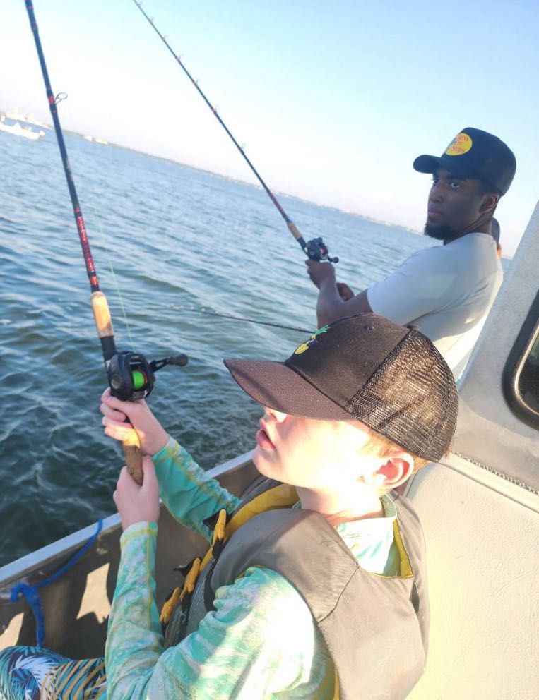 A person fishing at an unknown location.