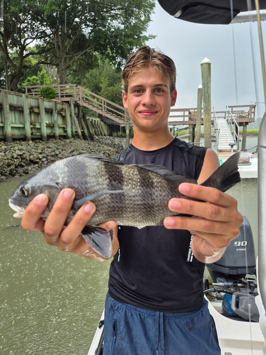 Reeling in a 20-inch Black Drum while storms brew on the horizon!