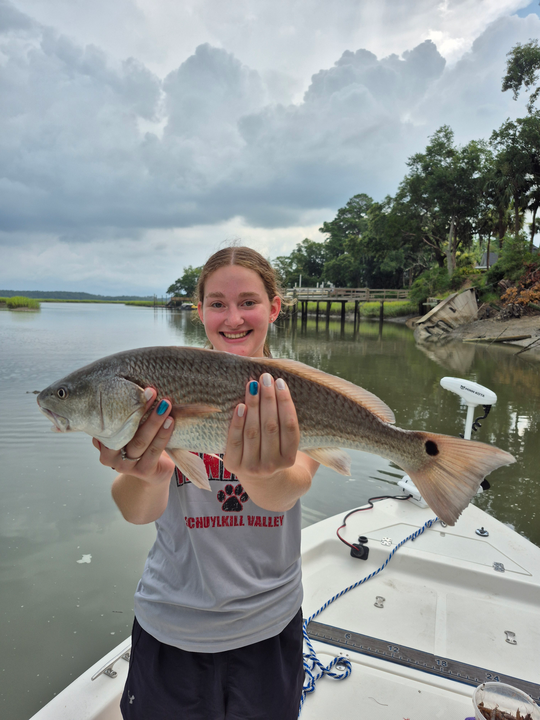 Huge 32-inch redfish reeled in on a partly cloudy day!