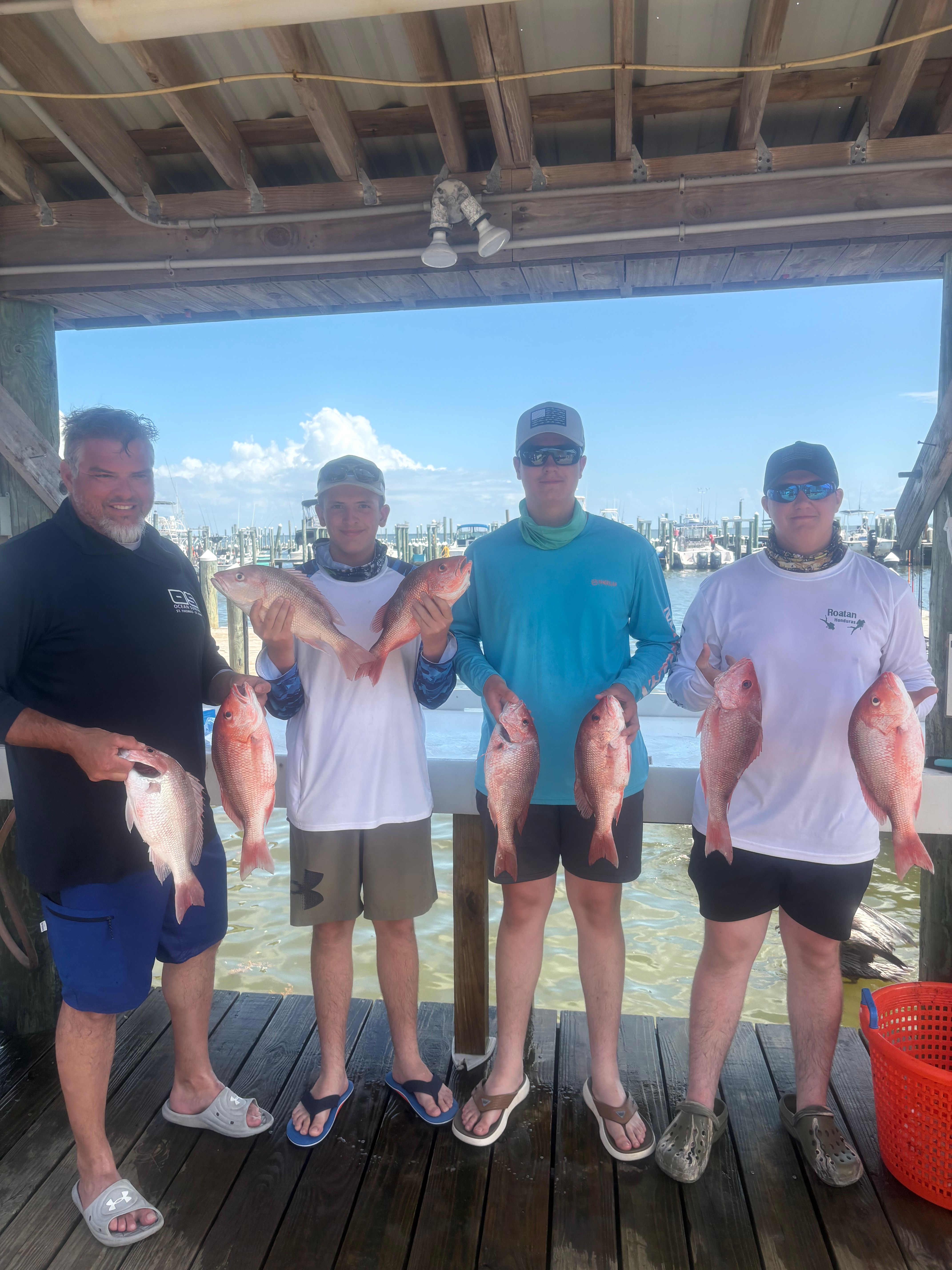 Fishing charter displaying catch of red snapper and grey snapper on boat deck