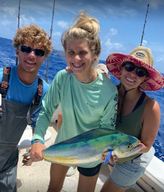 A group of 3 people fishing in an unknown location