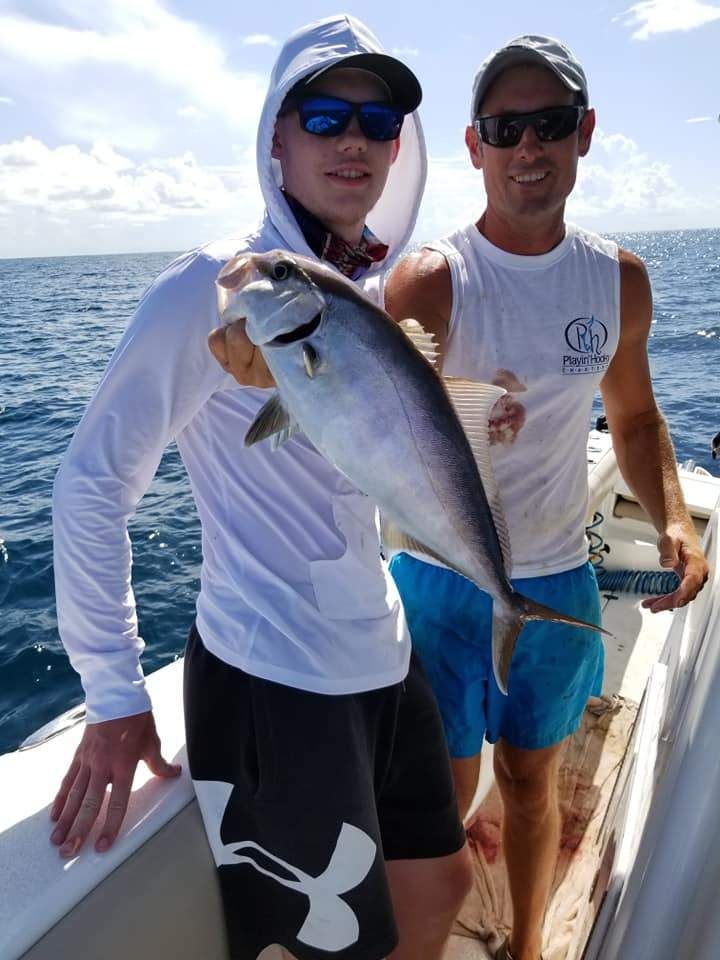 A person fishing in an unknown location