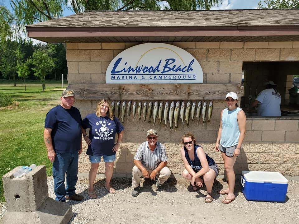 Group of 5 people fishing in unknown location