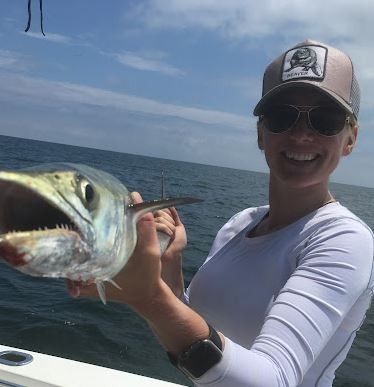 A lone fisherman with a fishing rod in an unknown location