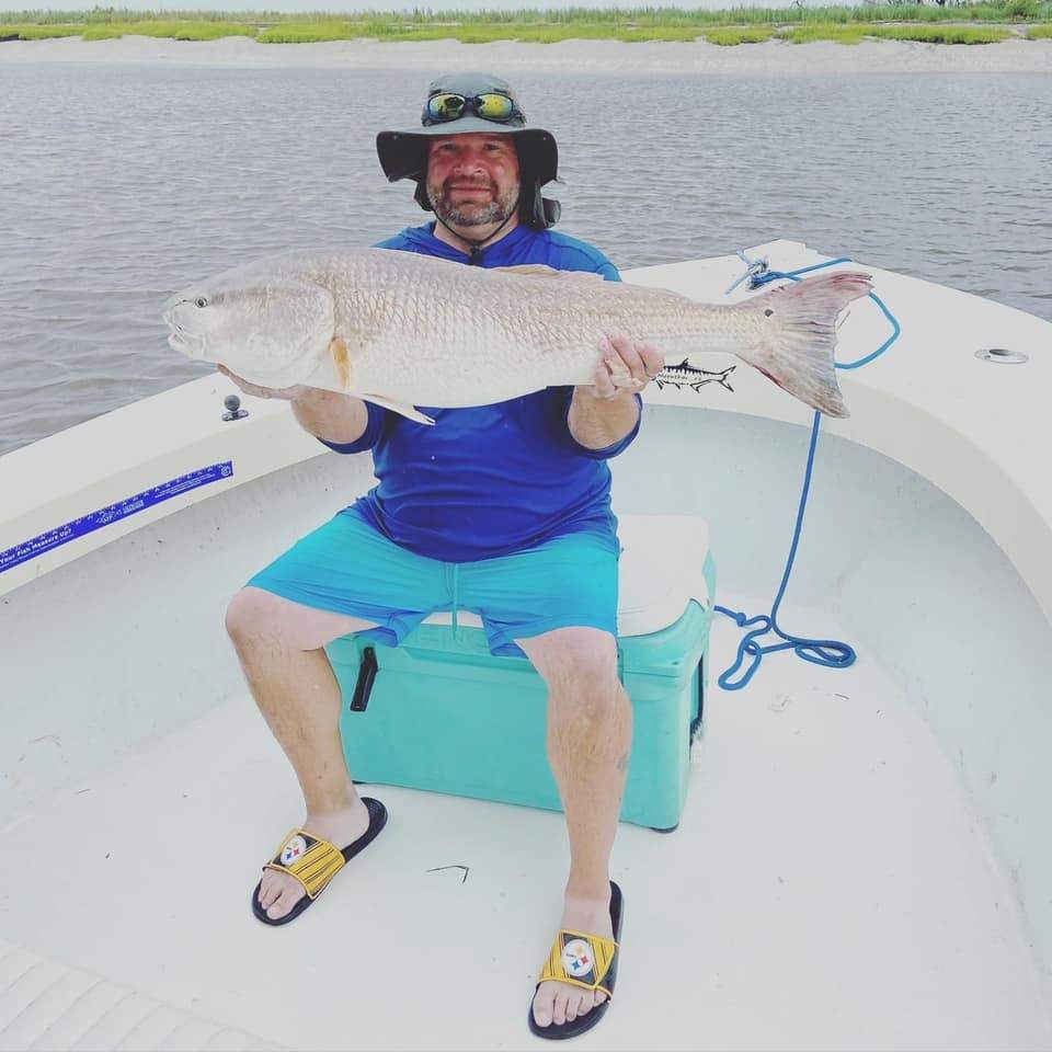 A lone angler fishing in an unknown location