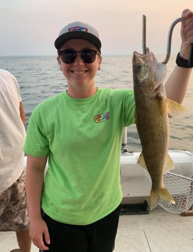Angler holding a walleye fish caught while fishing