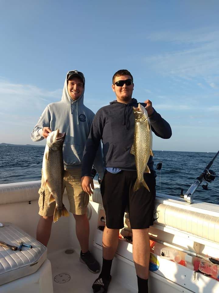 Two anglers with a catch of 2 big fish in an unknown location