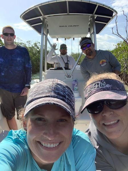 Group of 5 people fishing at unknown location