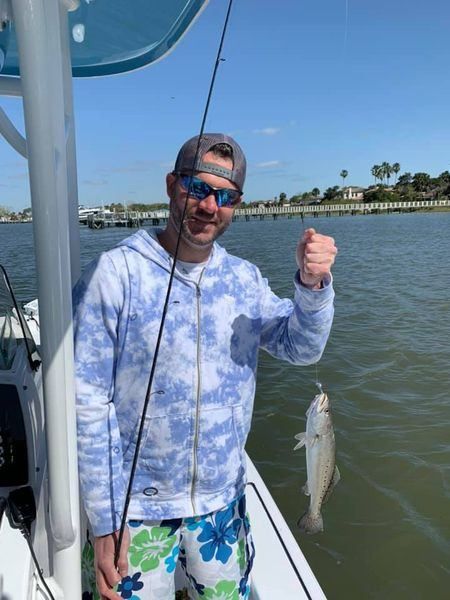 A person fishing in an unknown location