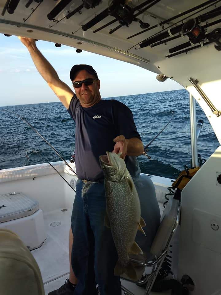 A fisherman with a large lake trout catch