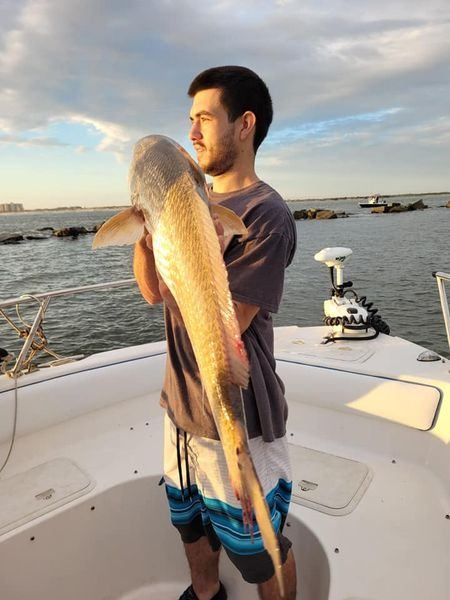 A person fishing in an unknown location