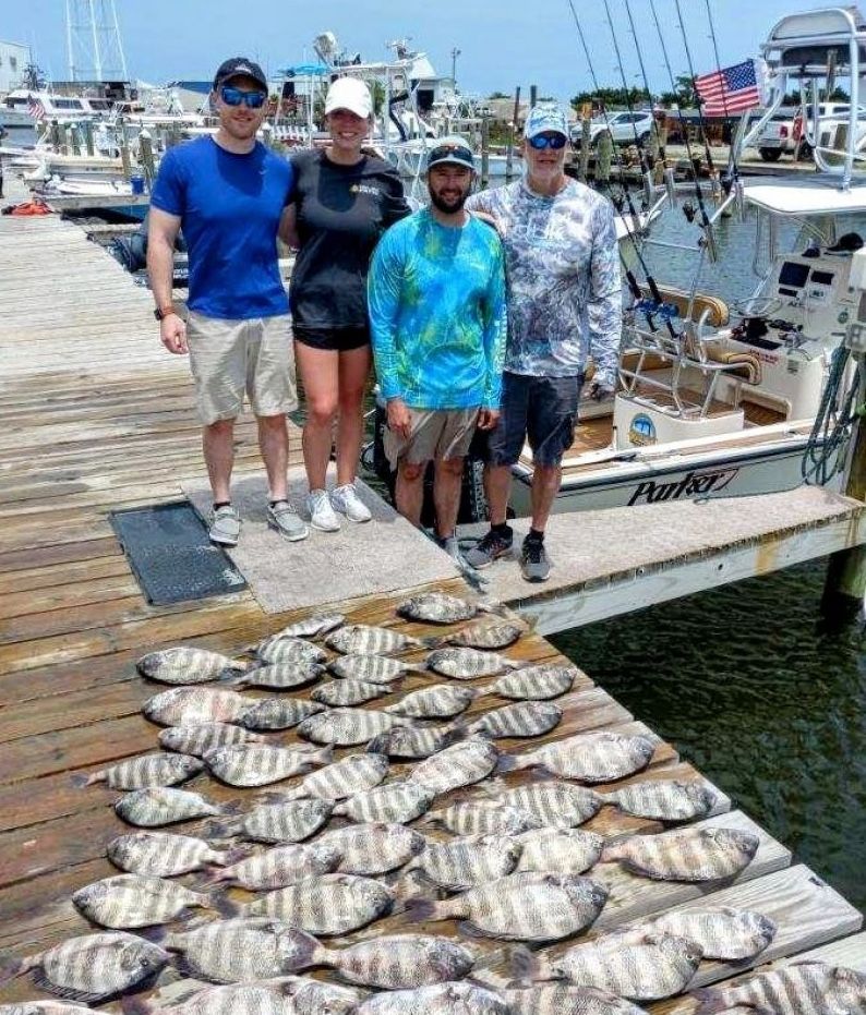 4 people fishing at a scenic location