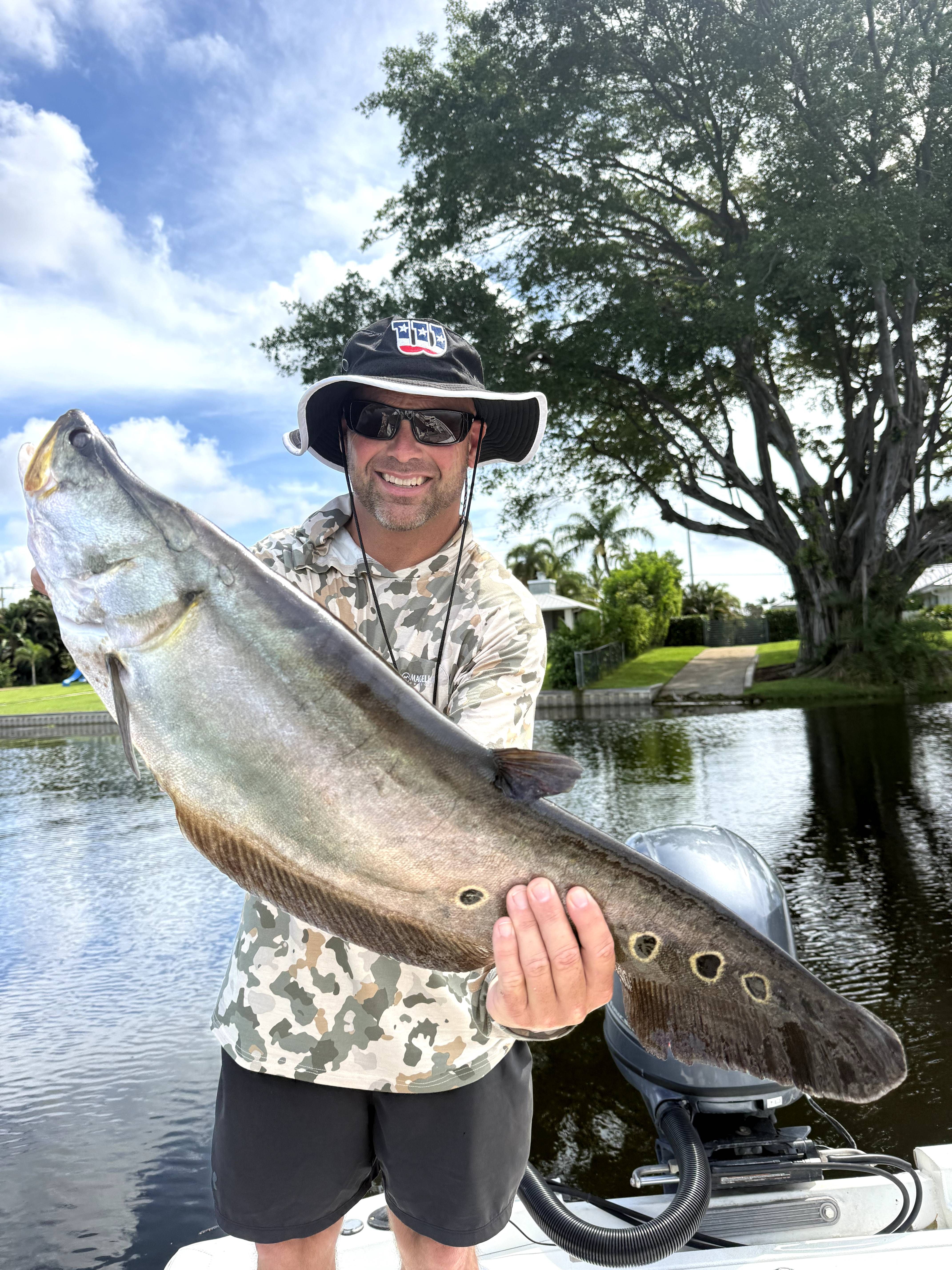 Large snook caught while fishing from boat on calm water