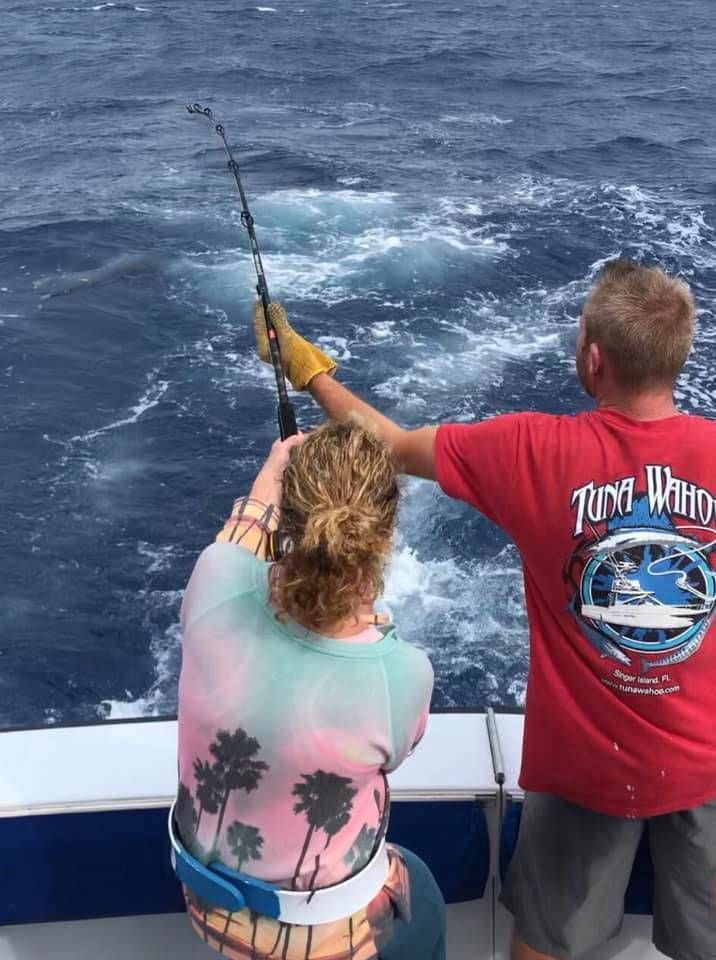 Angler holding a 6-inch fish during fishing outing