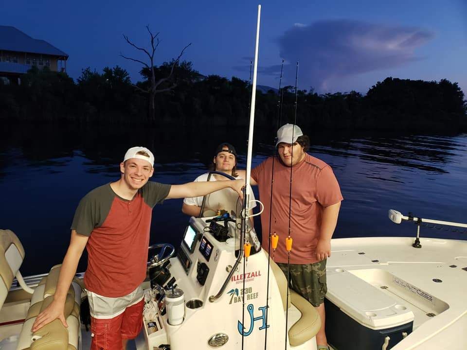 Three anglers fishing in a scenic location