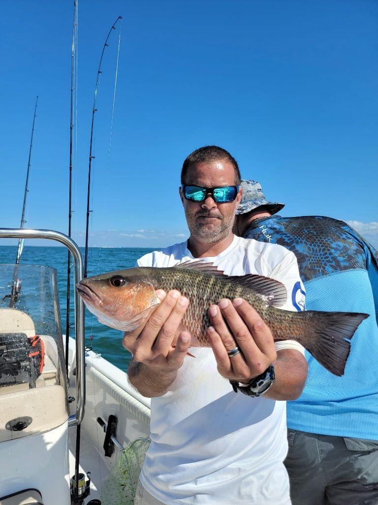 Image of 2 people fishing at an unknown location