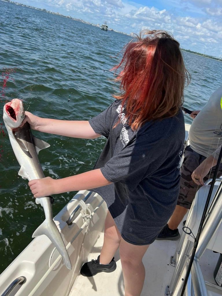 A bonnethead shark, a type of fish, in an unknown location while fishing