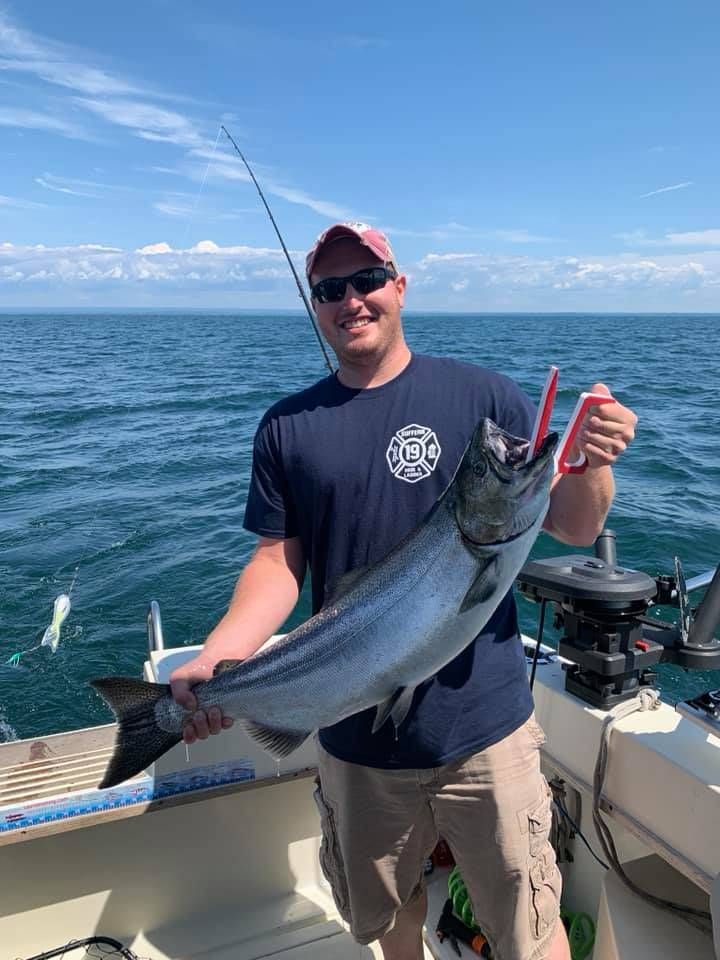 A person fishing in an unknown location