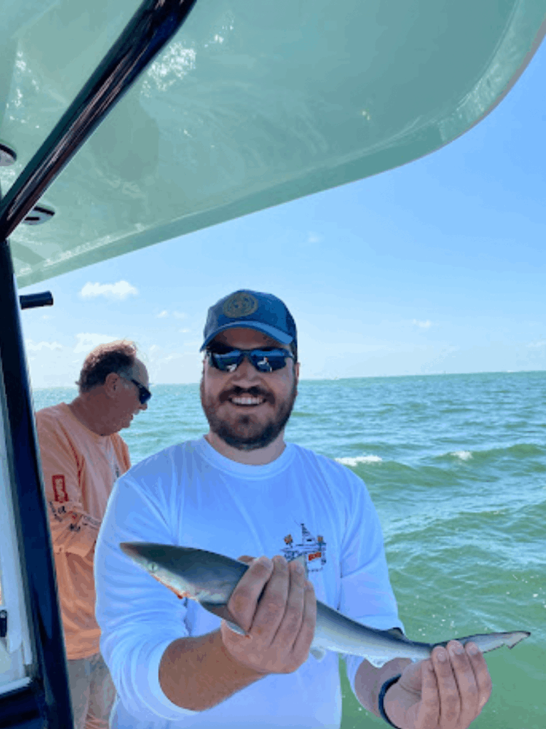 A person fishing with a rod in an unknown location.