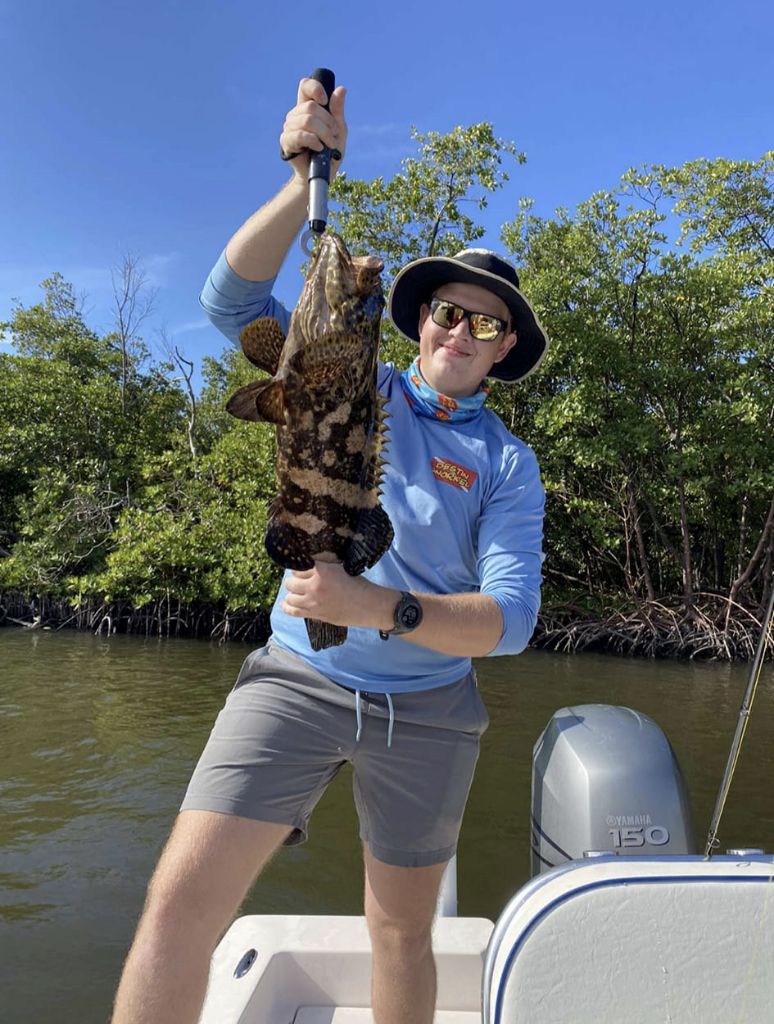 Angler fishing with rod in unknown location