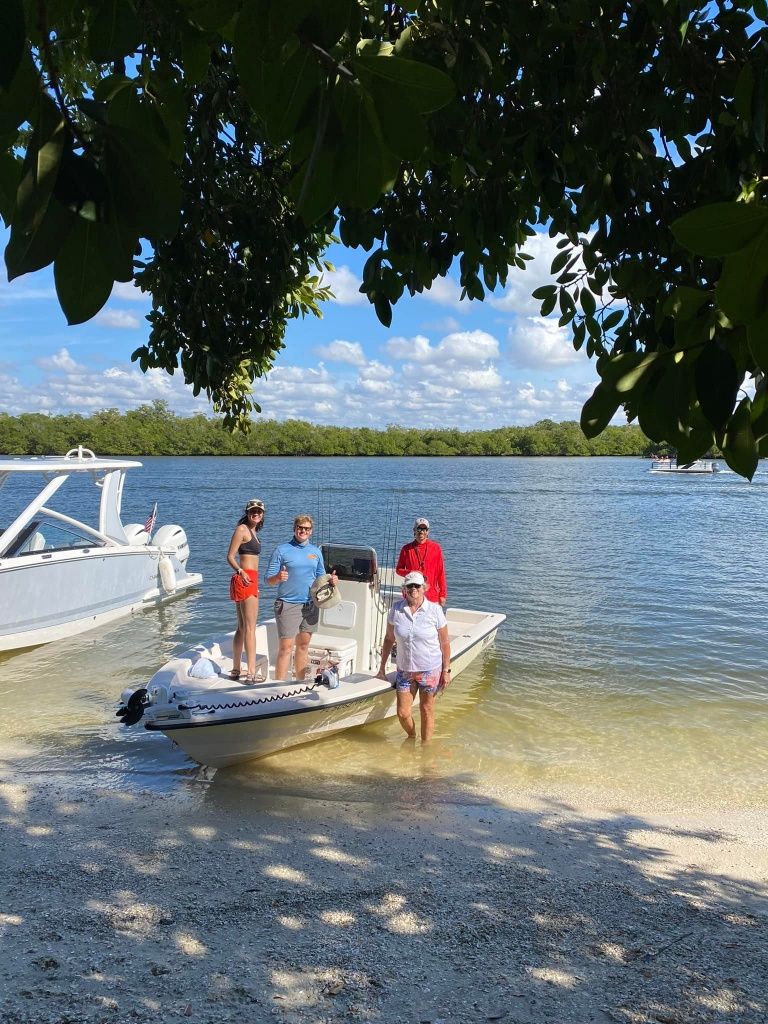 Four people fishing at a scenic location