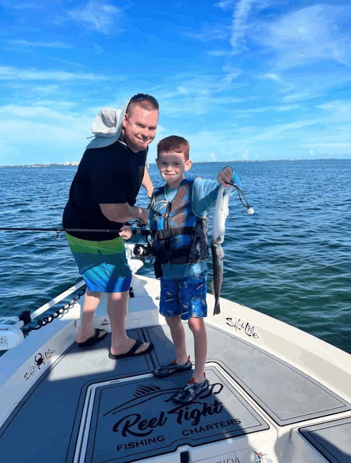 Two people fishing at a scenic location.
