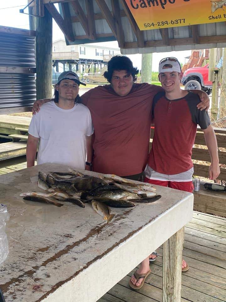 Three people fishing in a scenic location