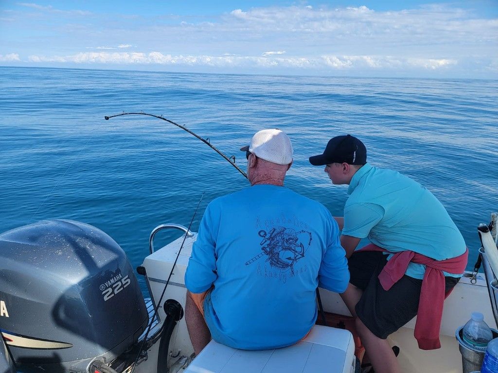 A person fishing in an unknown location