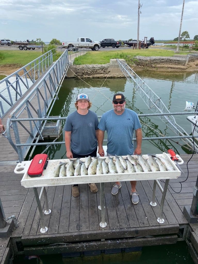 Two people fishing at an unknown location