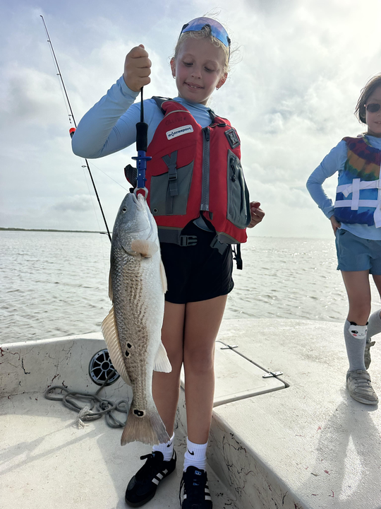 Big redfish reeled in during a stormy Matagorda adventure!