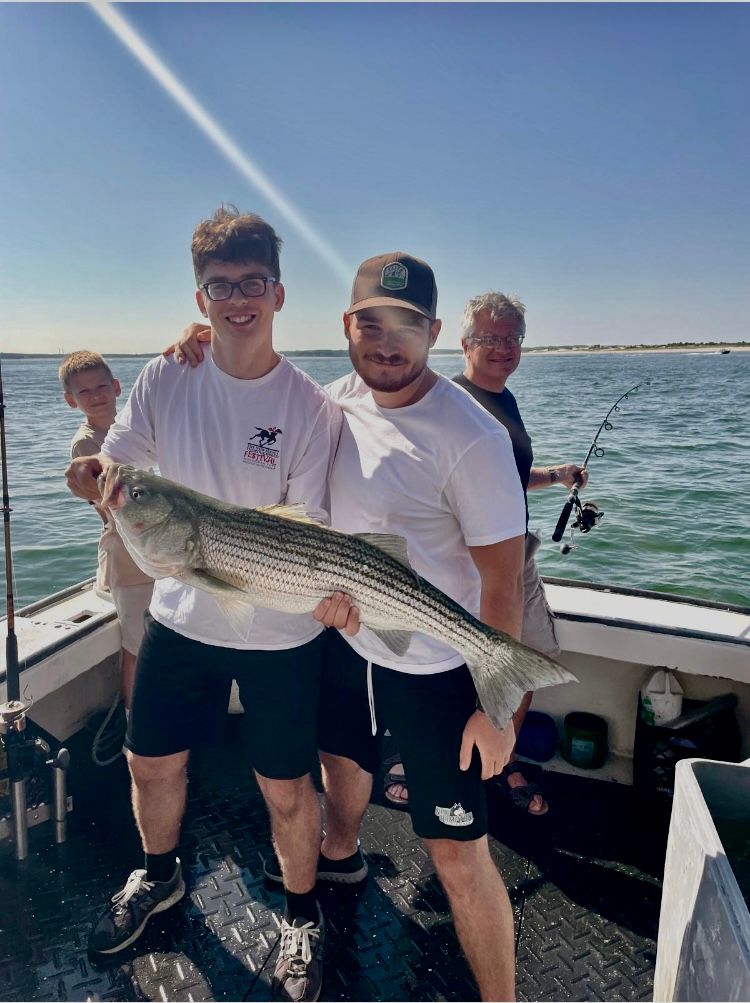 Striped bass caught by group of 4 people while fishing