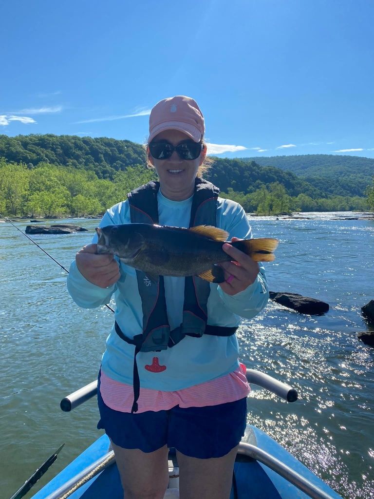 Angler with a 13-inch fish caught while fishing