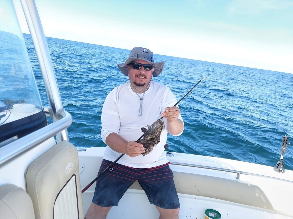 Angler catching a Black Drum fish