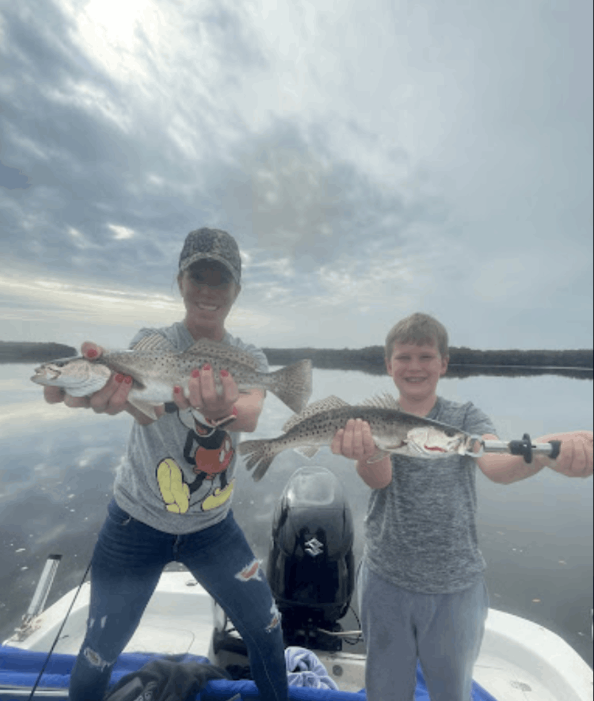 Two anglers fishing with big fish catch