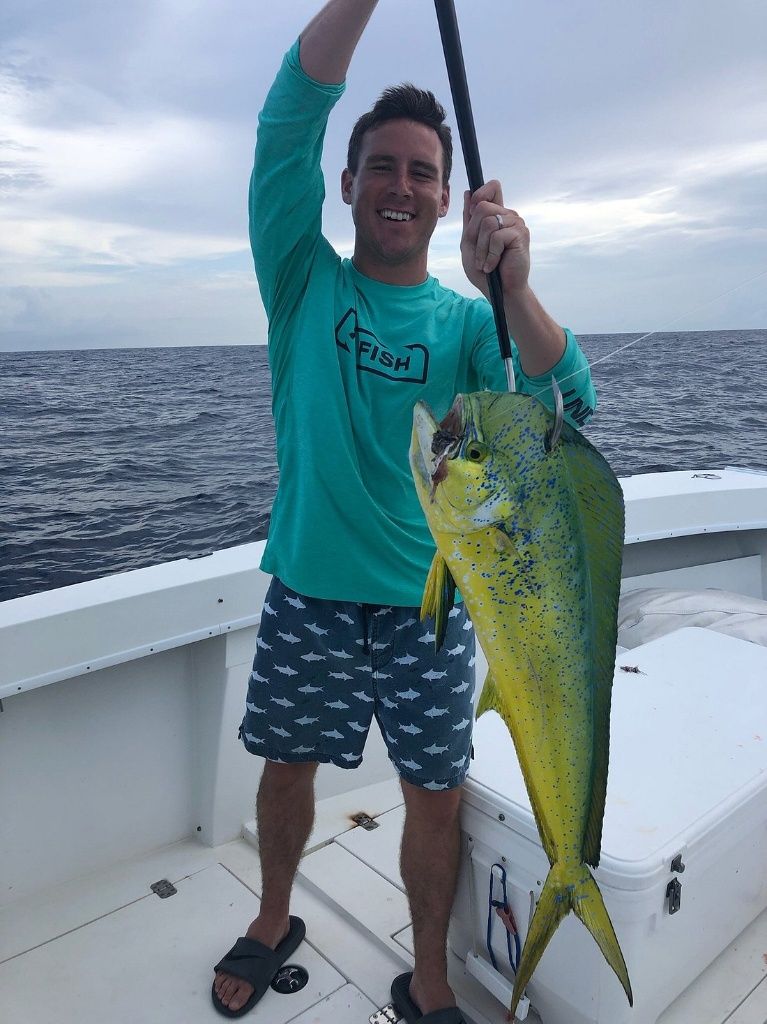 A lone fisherman reeling in a big catch at an unknown location